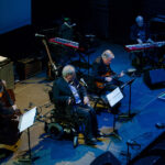 Blue stage photo of Canadian Jazz Vocalist Joe Coughlin performing with quintet for 'Salute to the Saloon Singers'